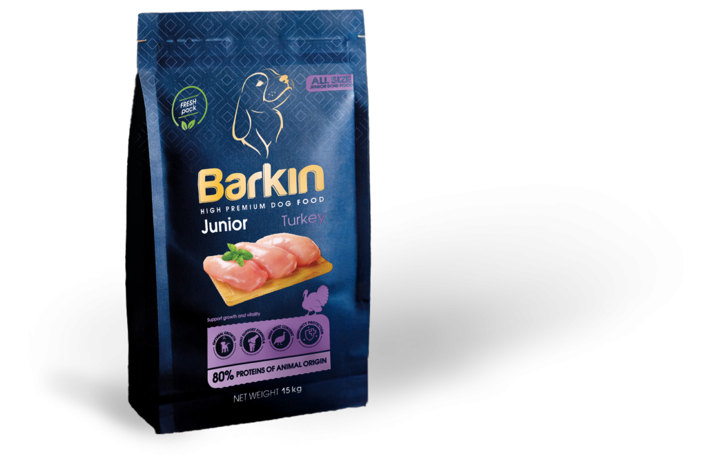 Busta di croccantini per cuccioli Barkin Junior Turkey, confezione blu scuro con accenti viola.